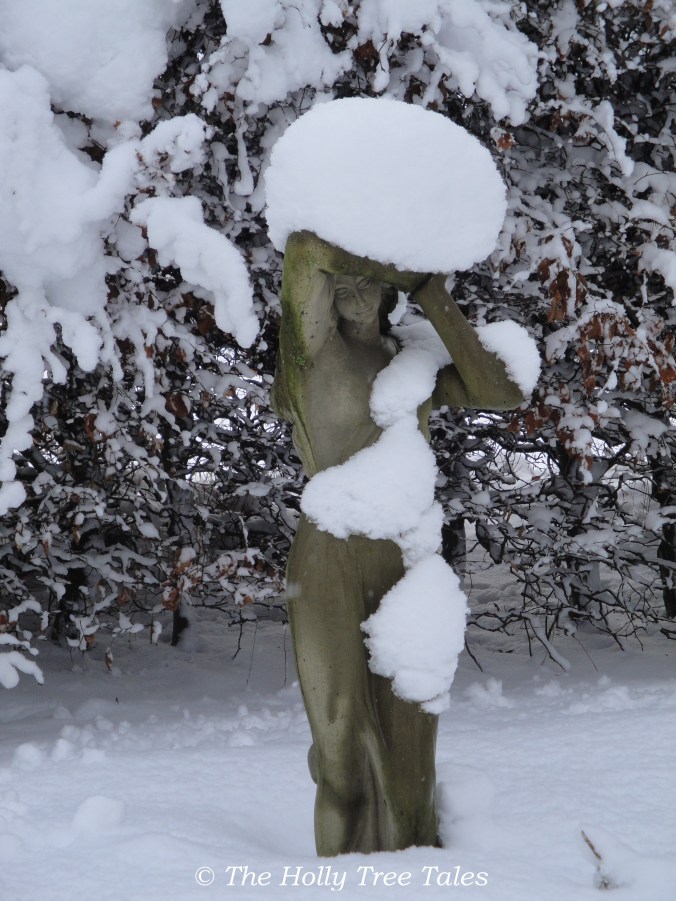 DSC09448 - Girl statue embraced by snow. Legerwood. Garden.  - copyright The Holly Tree Tales. com.