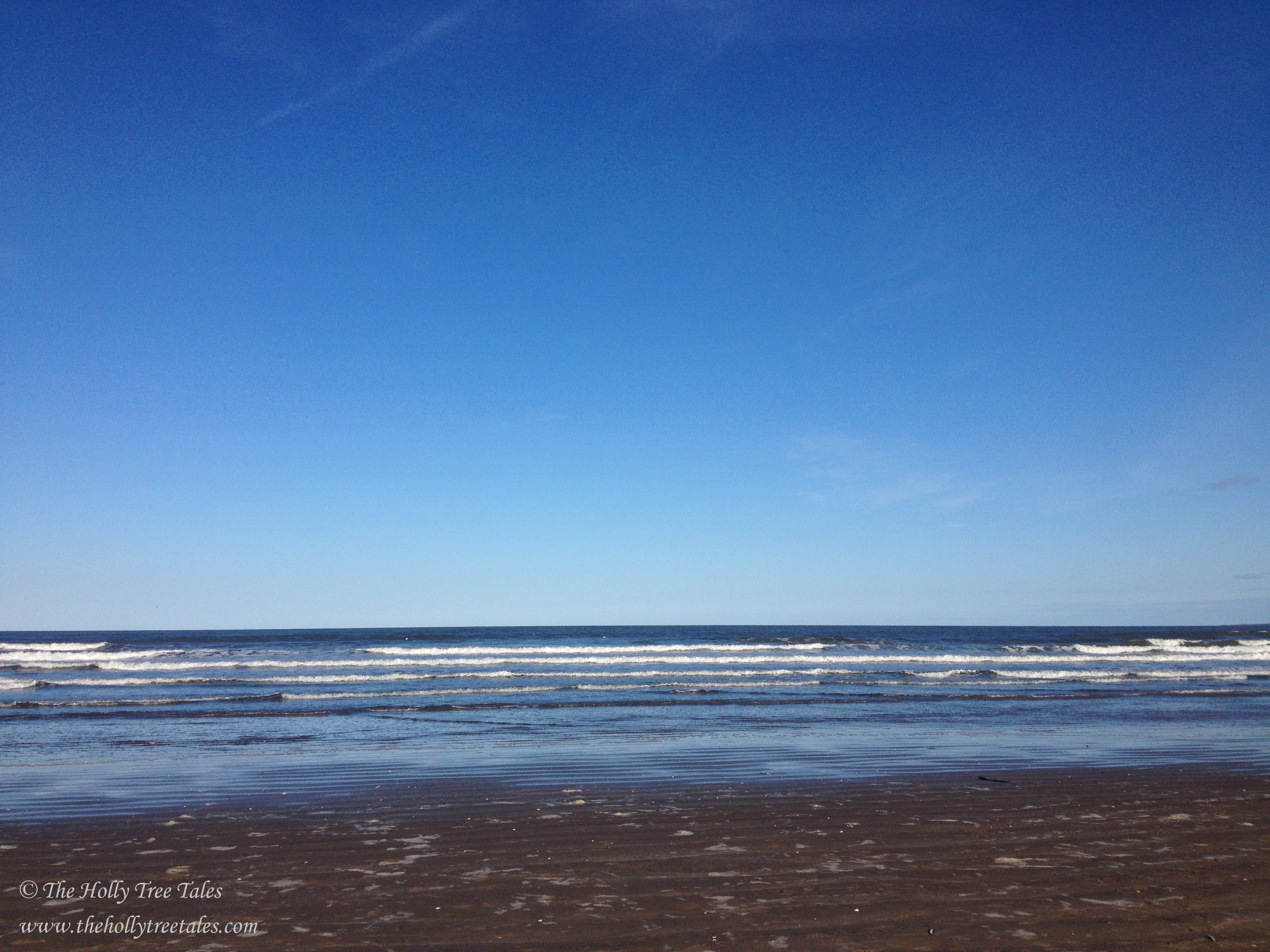 Deep blue sky, horizon, little waves lapping on the seashore. Signed (c) TheHollyTreeTales.com